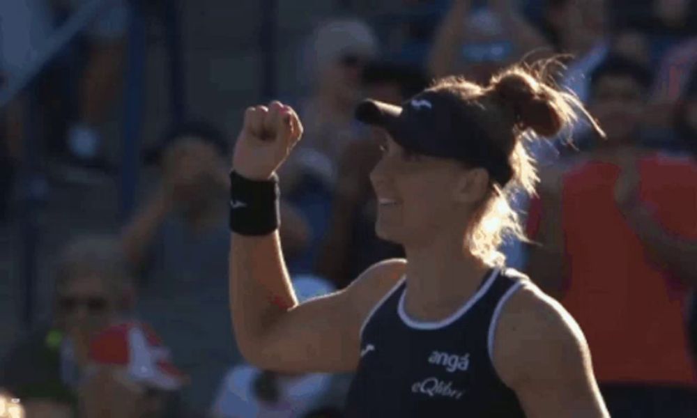 a woman holding a tennis racquet with anga written on it