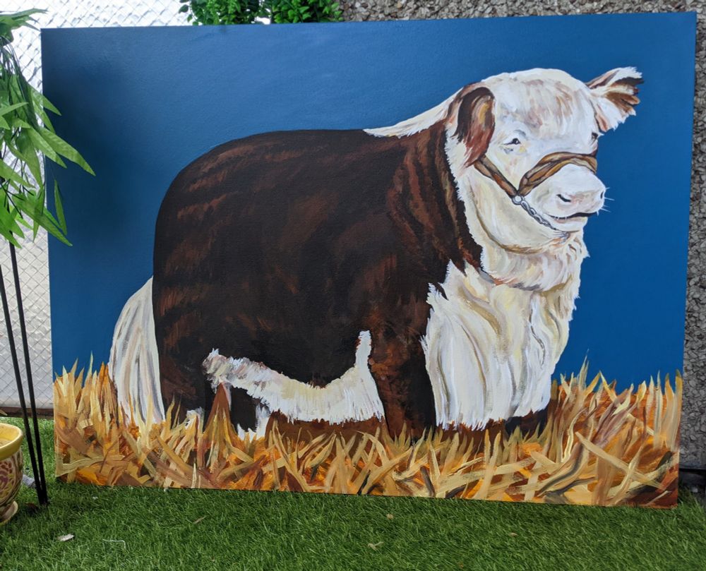 a massive acrylic painting of a very rectangular and fluffy cow standing knee deep in hay, with a blue background 