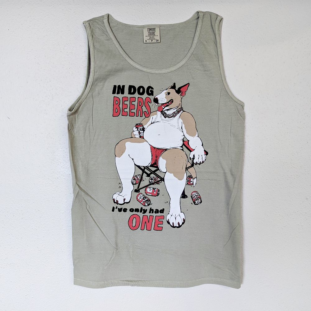 tank top of an anthropomorphic dog in a lawn chair surrounded by empty beers. Text reads: "In dog beers I've only had one"