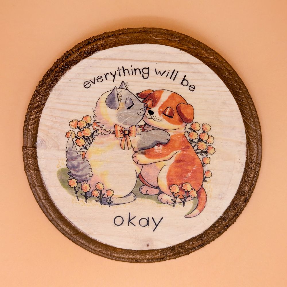 A plaque featuring a puppy and kitty hugging. Text reads: 