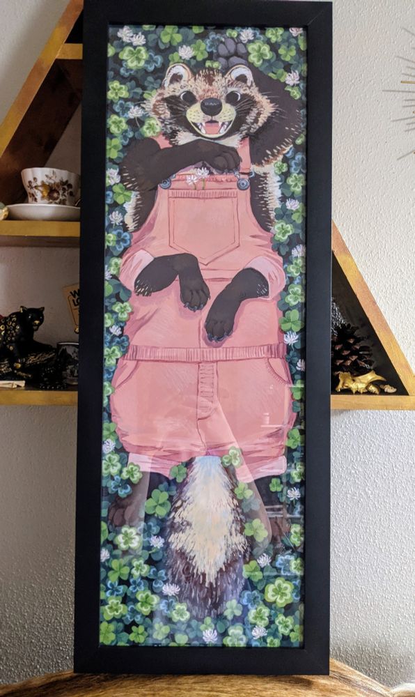 A painting of a tanuki taur in pink overalls lounging in clovers