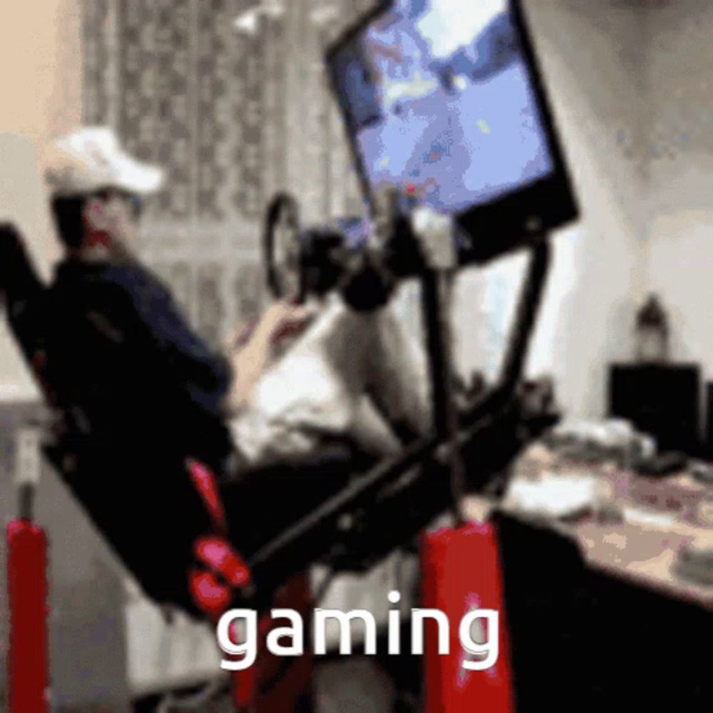 a man is sitting in a chair playing a video game and the word gaming is on the bottom