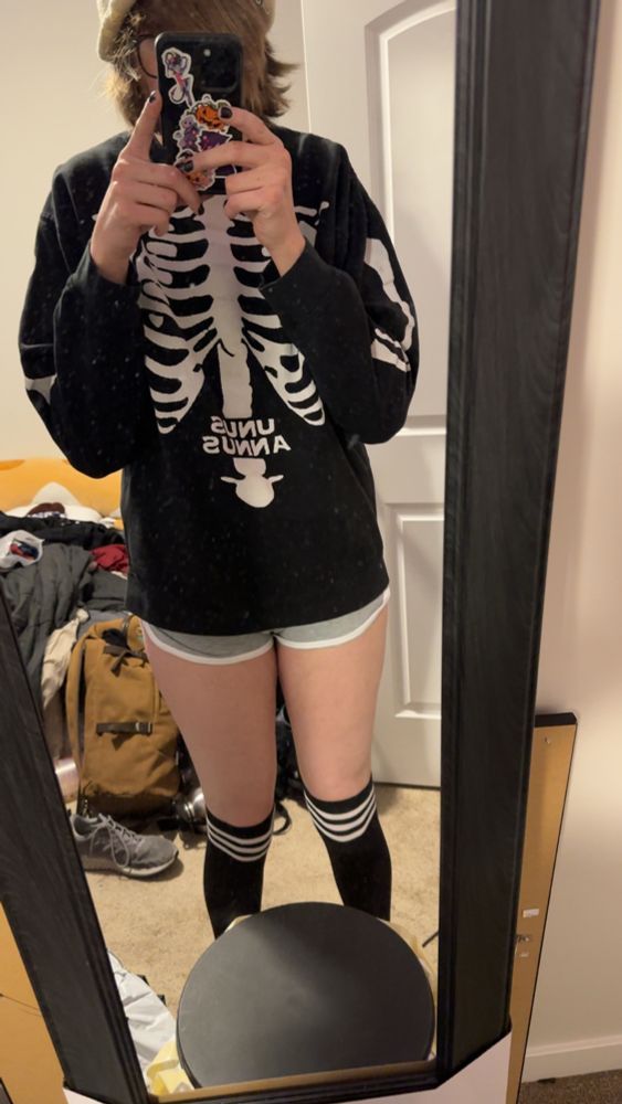 Knee high socks, light gray dolphin shorts, unus annus sweater, messy ass room 😭