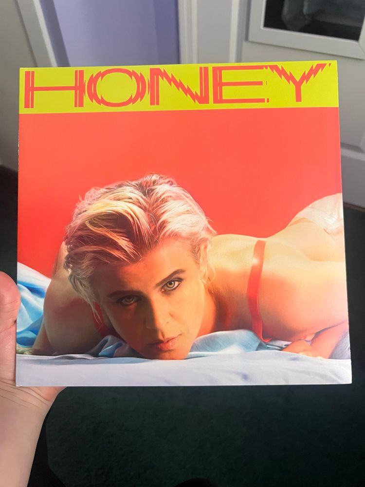 Me holding my LP of Honey by Robyn showing the cover
