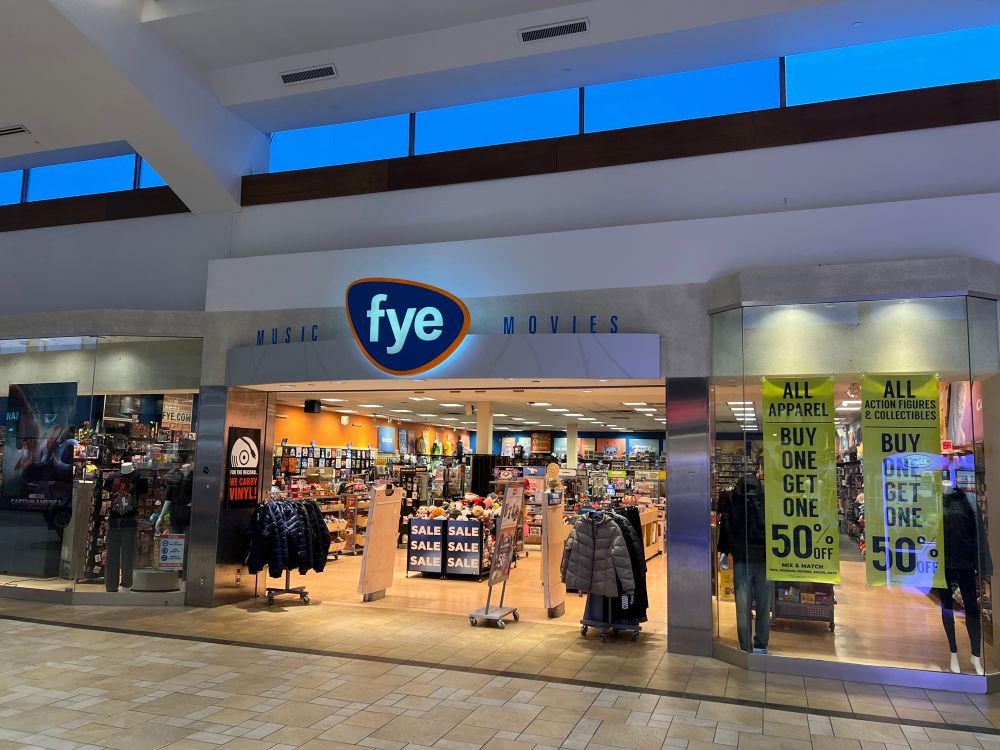 Exterior shot of an FYE store in a suburban mall, looks exactly how it did ~20 years ago, they’re still using the old logo