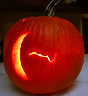 Crescent moon carved into pumpkin.