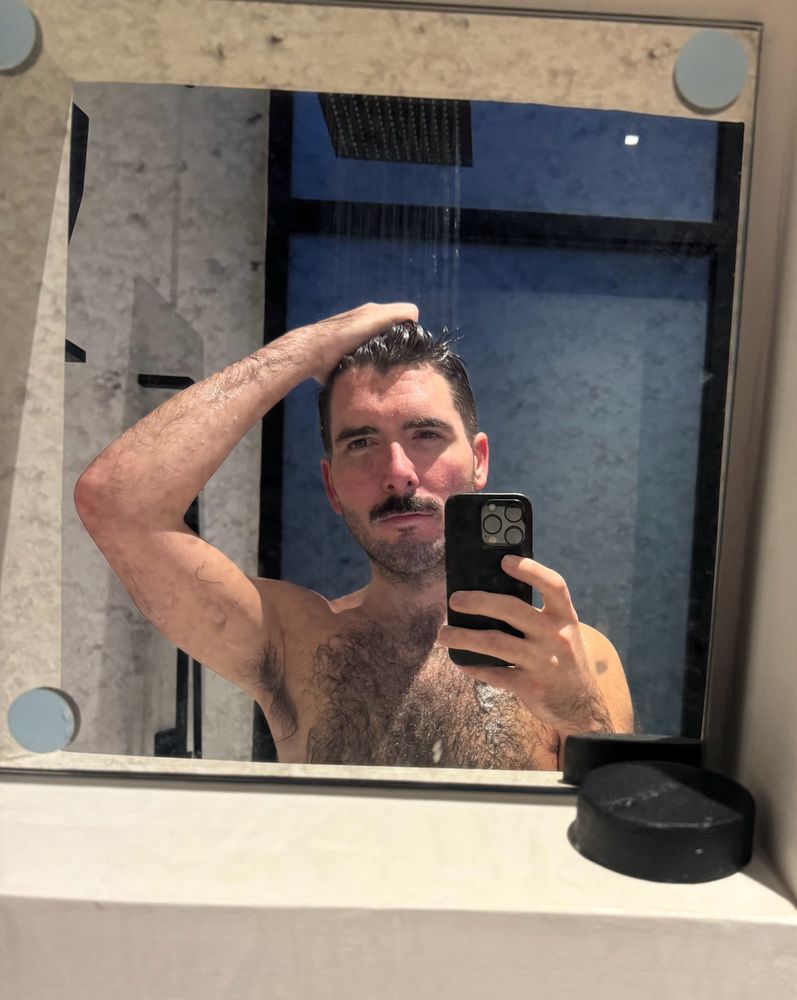 Gay posing in shower mirror with big mustache 