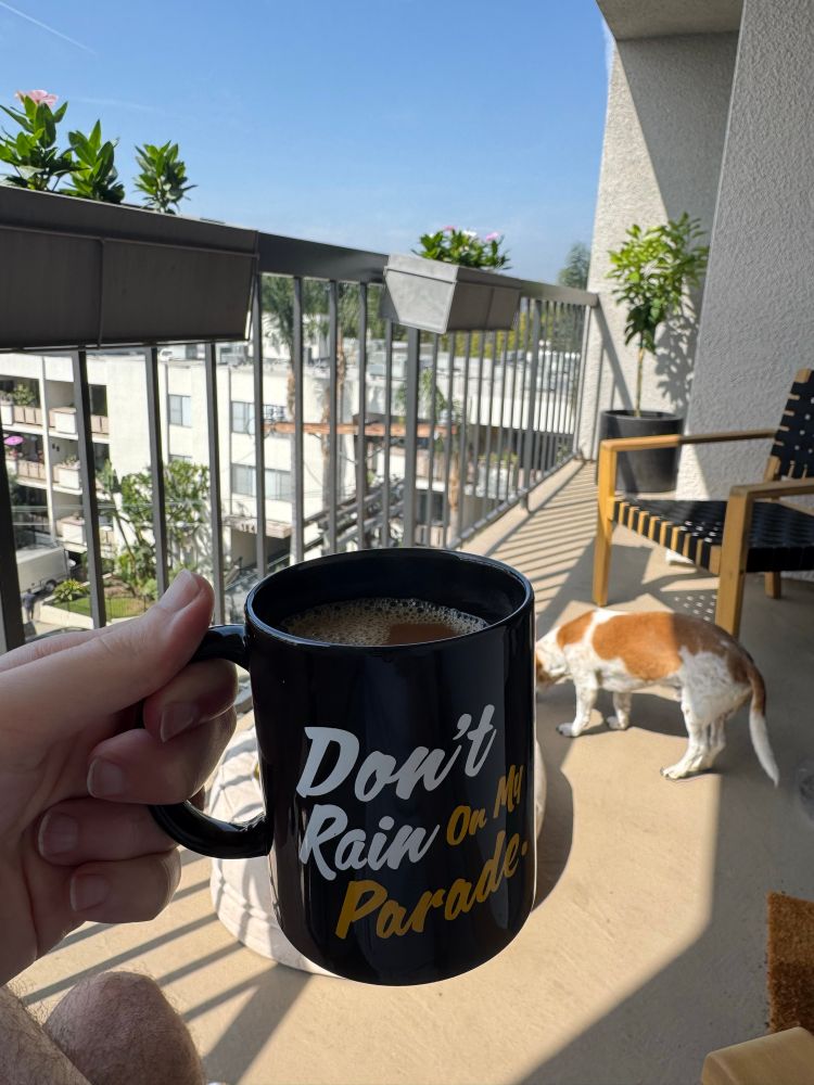 Drinking coffee in the sunshine on my balcony with my dog