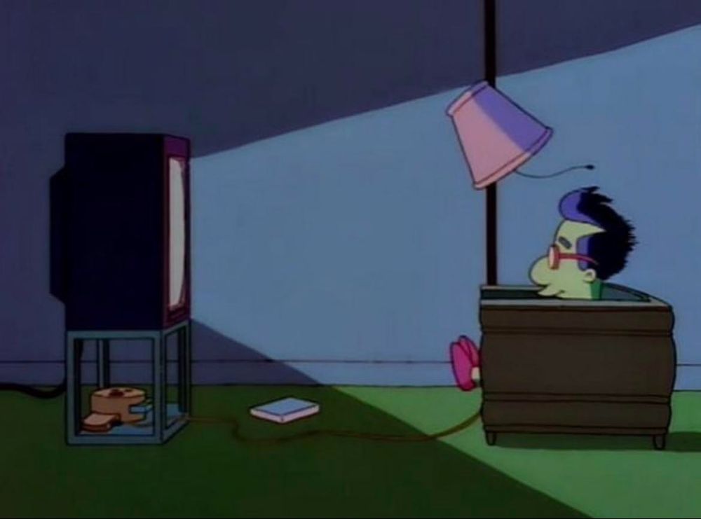 Milhouse from The Simpsons sat in front of a bright TV that is also so loud that it's pushing back his hair and objects in the room