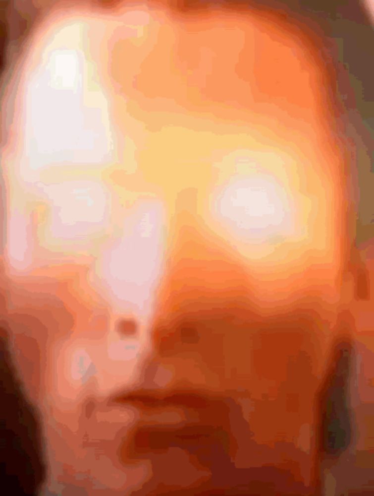 a close up of a person 's face with a glowing orange eye