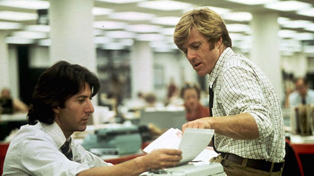Dustin Hoffman (as Carl Bernstein) holding a piece of paper which Robert Redford (Bob Woodward) points to in the Washington Post newsroom. From the film All The President's Men