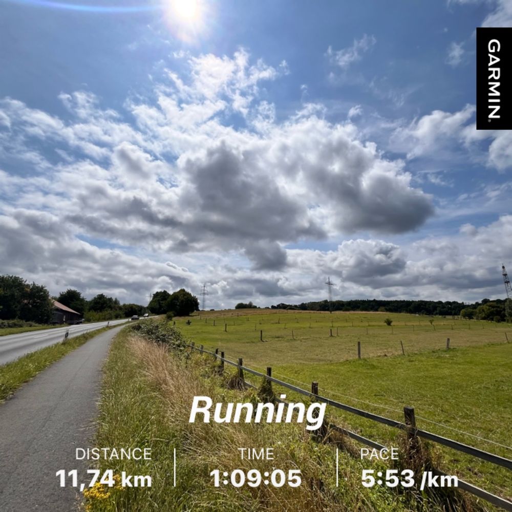 Image of a bike path near a country road under a blue sky
