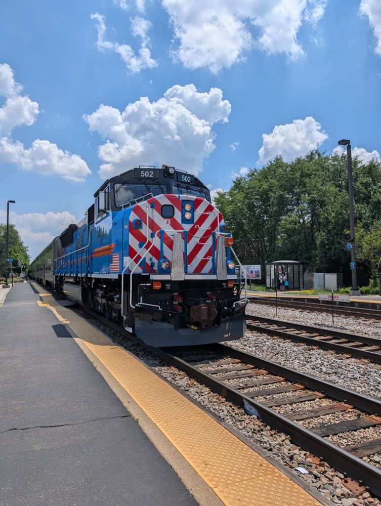 Metra train arriving at a station platform.