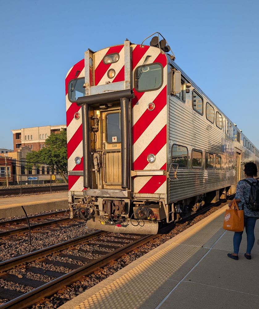 Metra train arriving at a station platform.