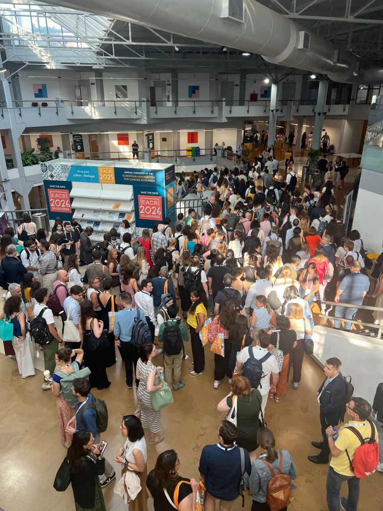 EACR Conference attendees gathering in the main hall at the event - photo taken from the balcony showing the many people attending