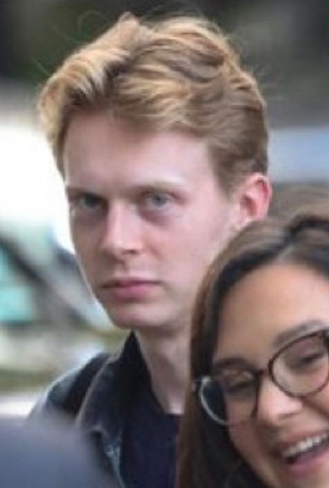 One such “beefy” and “chiseled” bodyguard. Scrawny red headed man looking at the camera like he wants to know what your skin tastes like. 