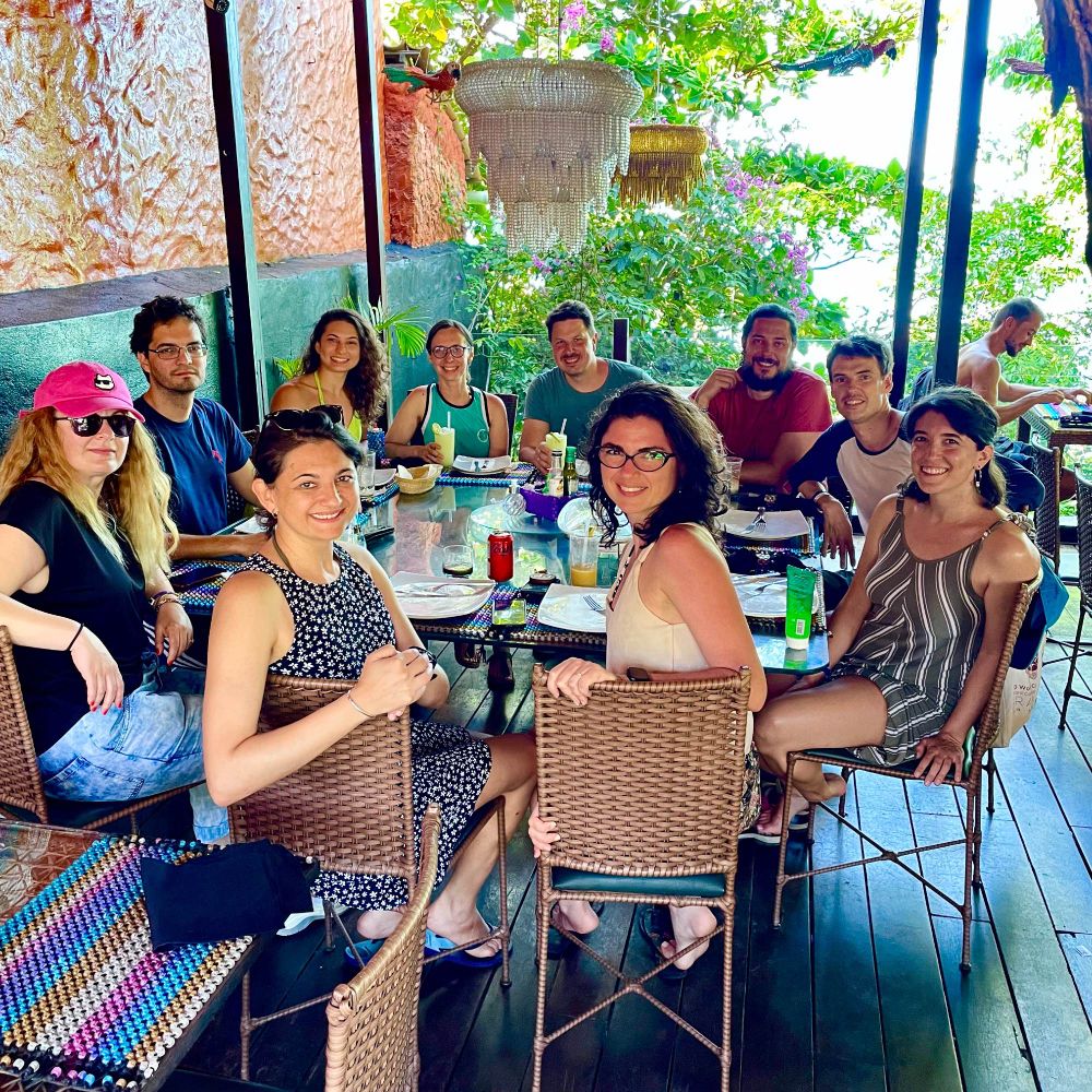 A group of conference organisers, speakers, and students at lunch in Pipa!