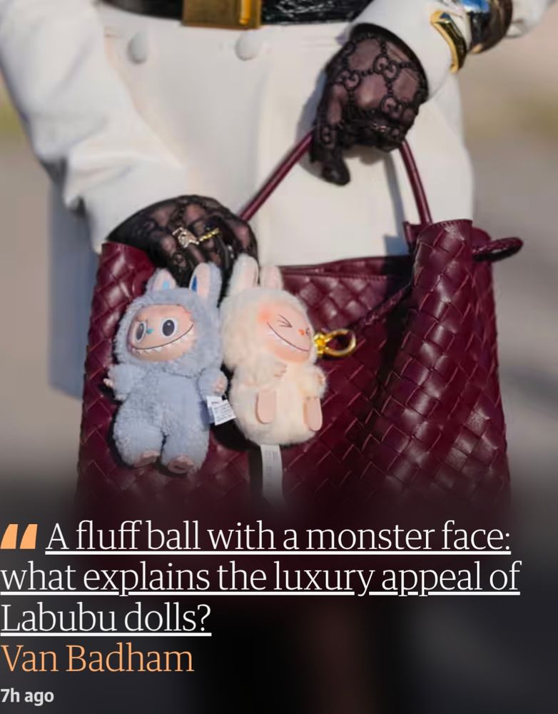 An image of a lace gloved hand holding a luxury leather handbag, with two stuffed toys accessorising. Over the image is a headline for a Van Badham column at The Guardian: "A fluff ball with a monster face: what explains the luxury appeal of Labubu dolls?"