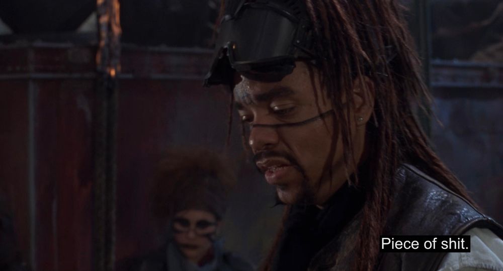 Ice-T with a circle A tattoo on his forehead with subtitle "Piece of shit."