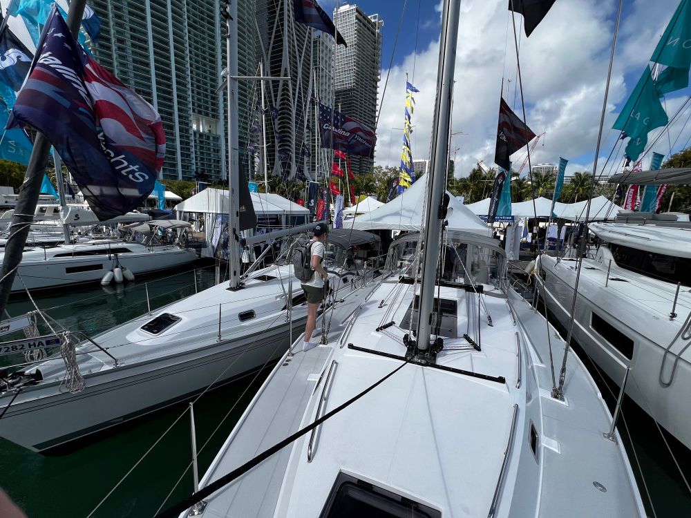 A photo from the bow of a sailboat looking back across all the boats at the show.