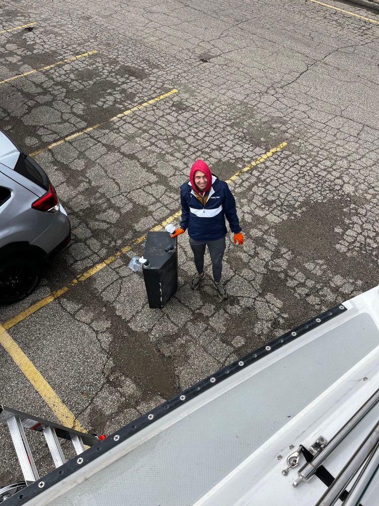 My husband posing next to our sailboat’s removed black water tank (sewage tank)