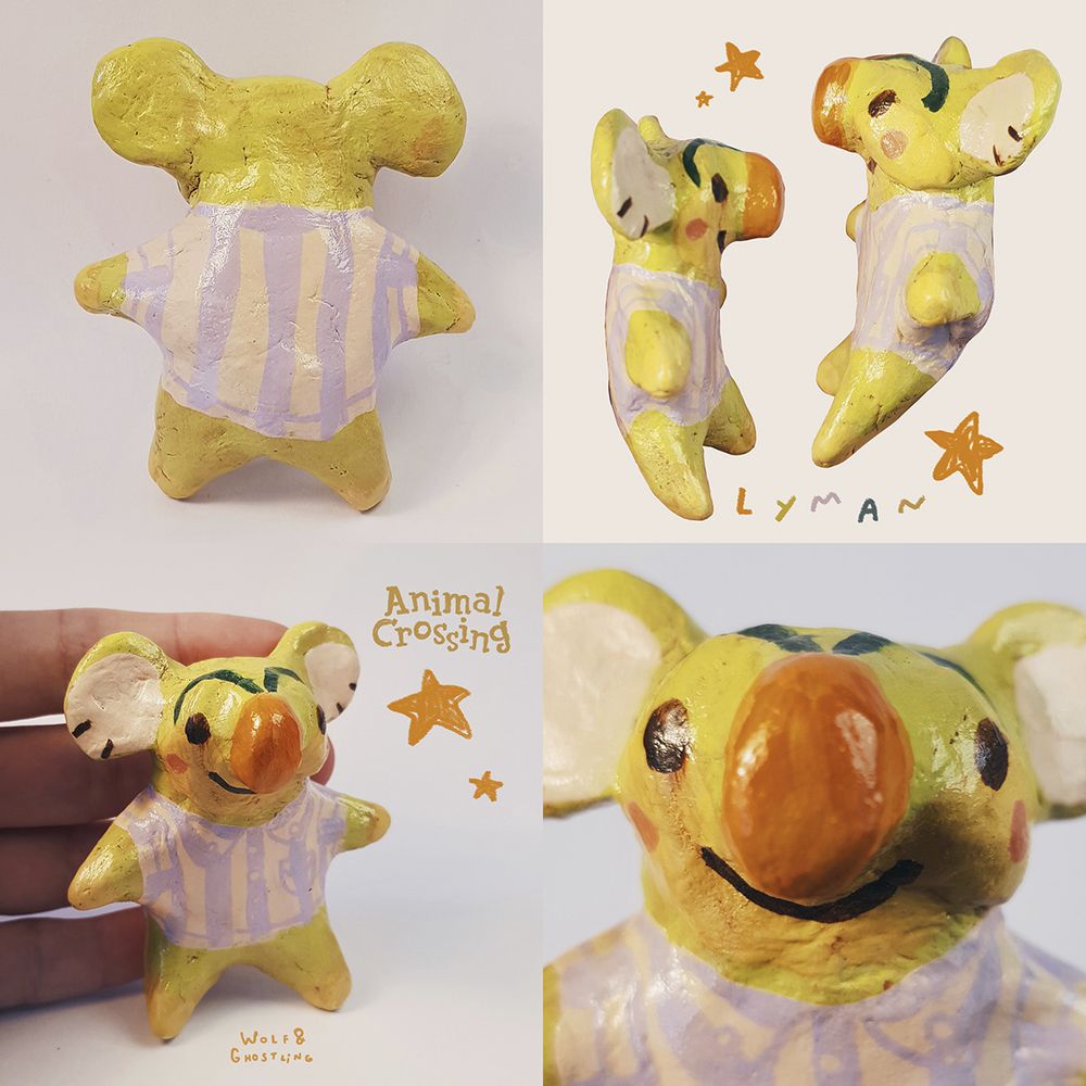 a little sculpture of animal crossing character lyman, who is a lime green koala with nose and eyebrows that look like a carrot