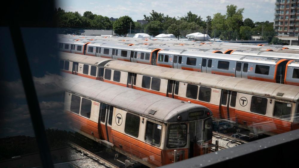 Orange line trains lined up in a railyard in Boston