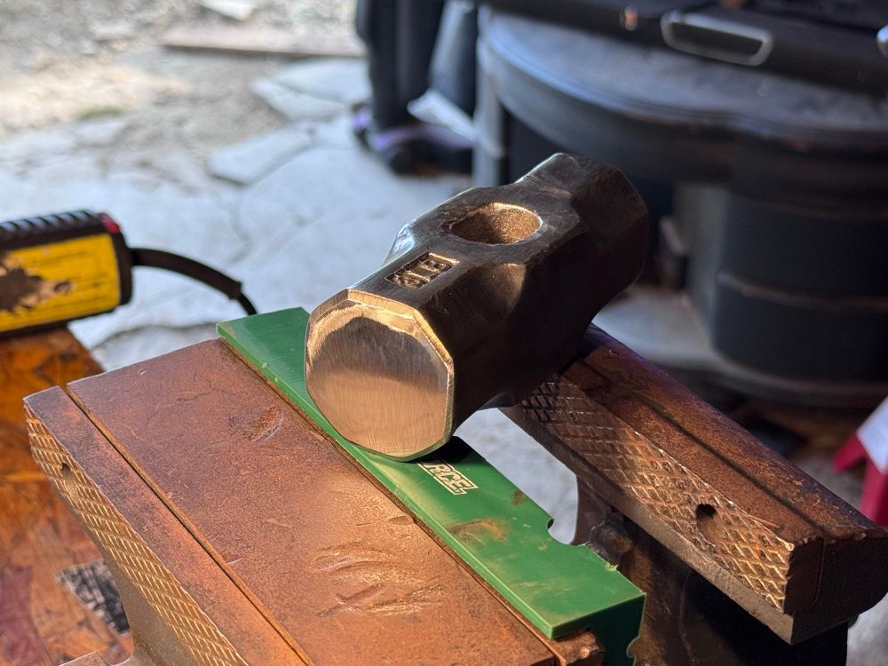 Cleaned hammer head sitting in the vice 