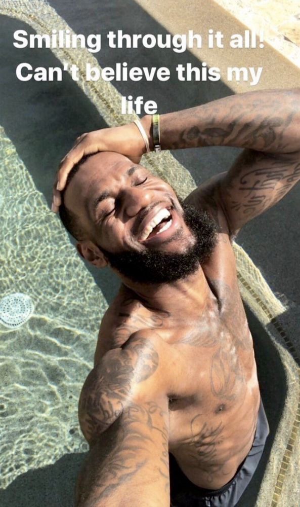 ohio legend lebron james grins while standing in a pool with the text "smiling through it all! can't believe this my life" over the image