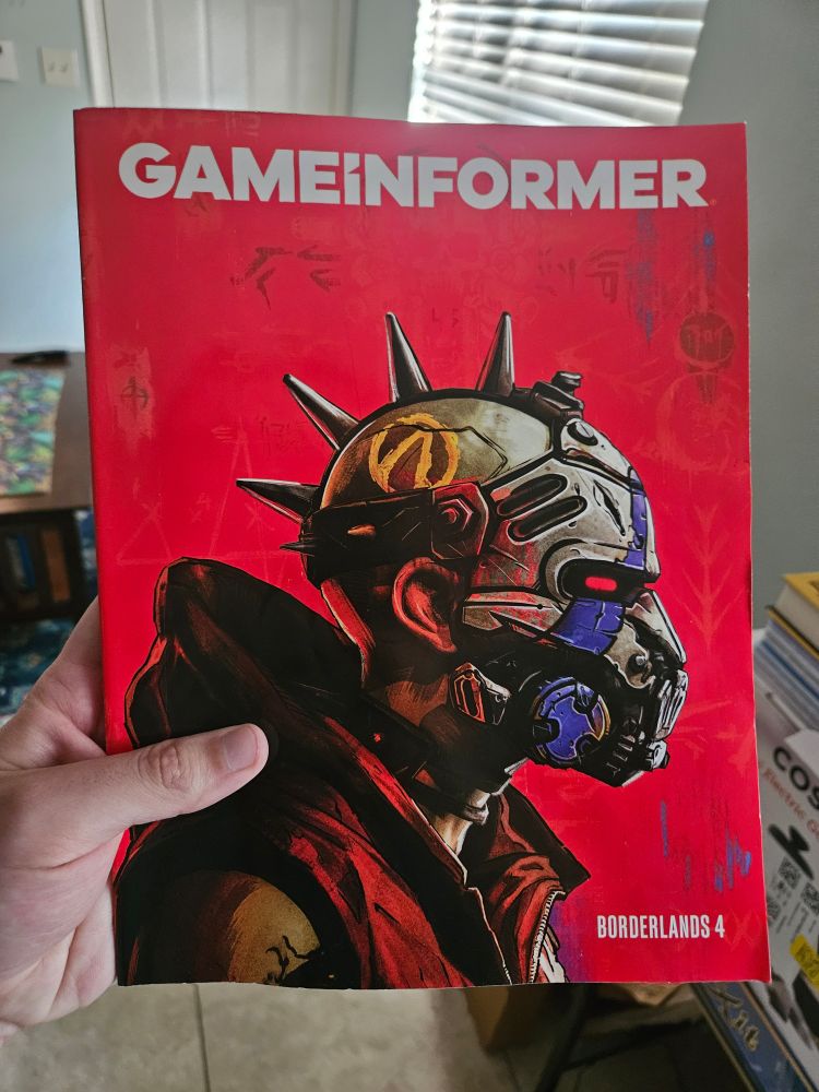 A human in a Psycho mask in profile on the striking Borderlands 4-themed red cover of the latest Game Informer.