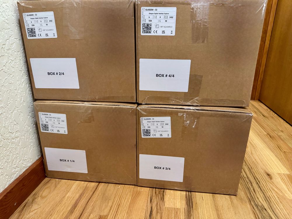 Four brown boxes with white labels. The labels indicate they contain Glasgows. Each box contains 50 Glasgows.
