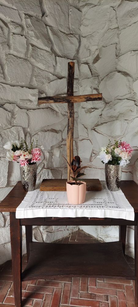 Wooden cross and flowers.