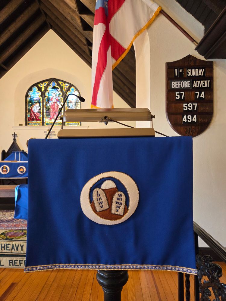 Church lectern with O Antiphon symbol: O Adonai.