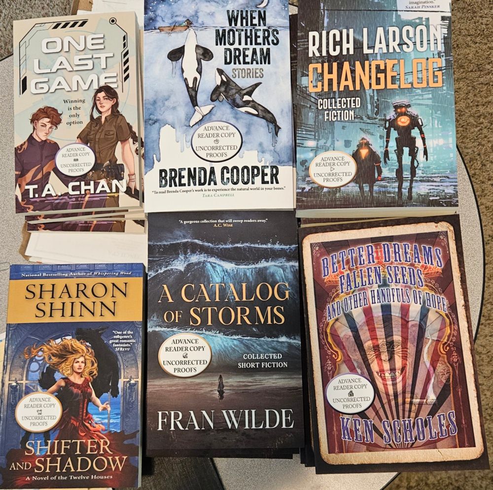 6 advance reader books showing front covers for T.A. Chan, Brenda Cooper, Rich Larson, Sharon Shinn, Fran Wilde, and Ken Scholes