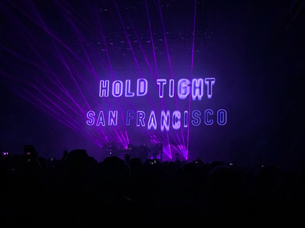Floating text with lasers that says “hold tight San Francisco”