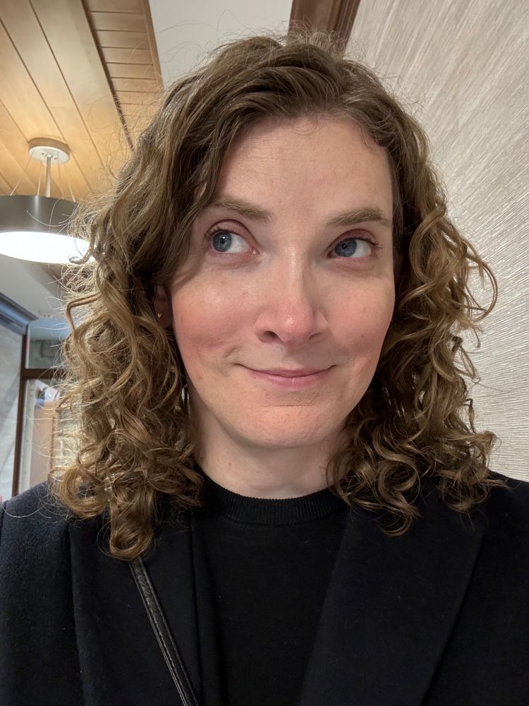 A quick selfie of Elizabeth, taken Christmas morning. She’s smiling and looking away from the camera with her eyes.