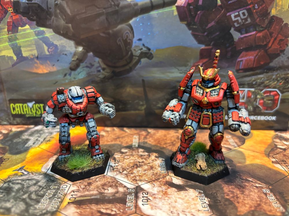 Battletech miniatures. A Kintaro and a Hatamoto-Chi in Legion of Vega colors.