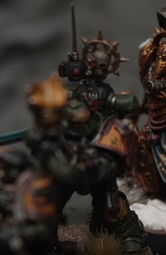 Space Marine with MK 2 "Iron" pattern armor with a MK4 "Maximus" pattern helmet and a Nuncio Vox on the power pack.