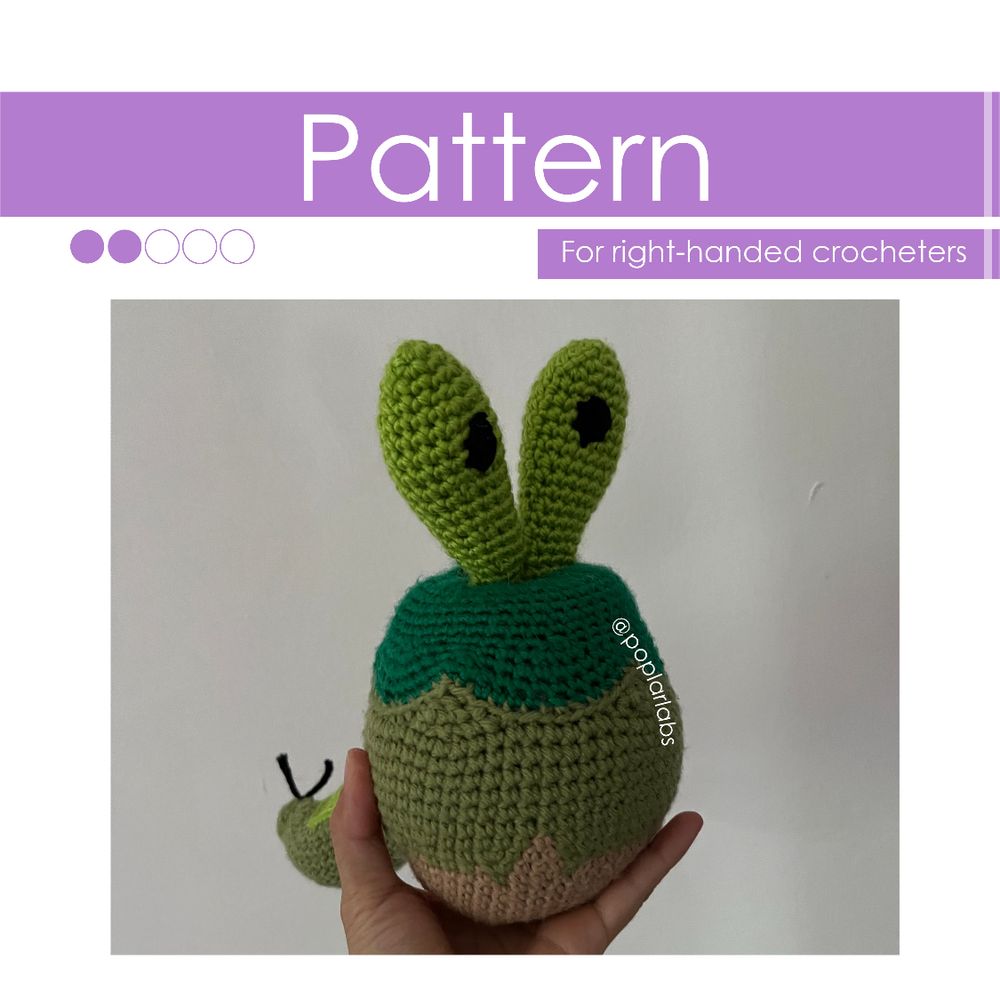 A crocheted amigurumi plush toy of Shiny Applin from Pokémon Sword and Shield. Above Applin is a purple banner that reads “Pattern for right-handed crocheters.”