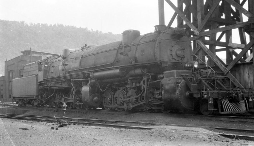 A black and white photograph of a massive articulated steam locomotive. The cylinders are huge, and the boiler even bigger. 