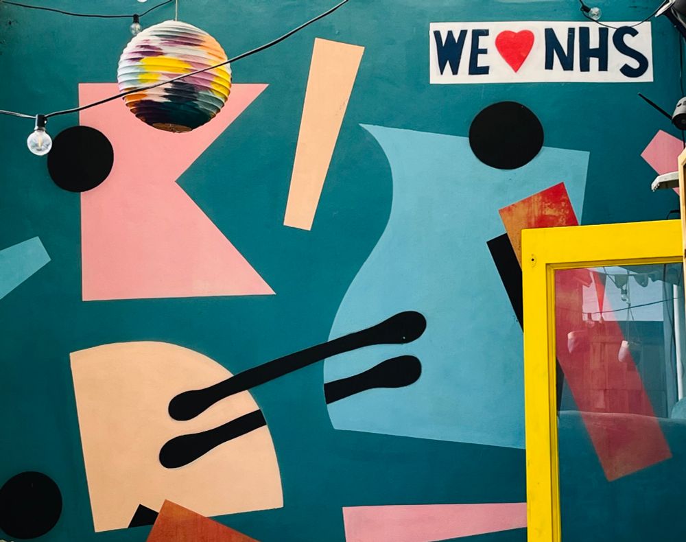 Colourful mural on the terrace wall of Penfolds coffee shop in central Bristol including ‘We love NHS’