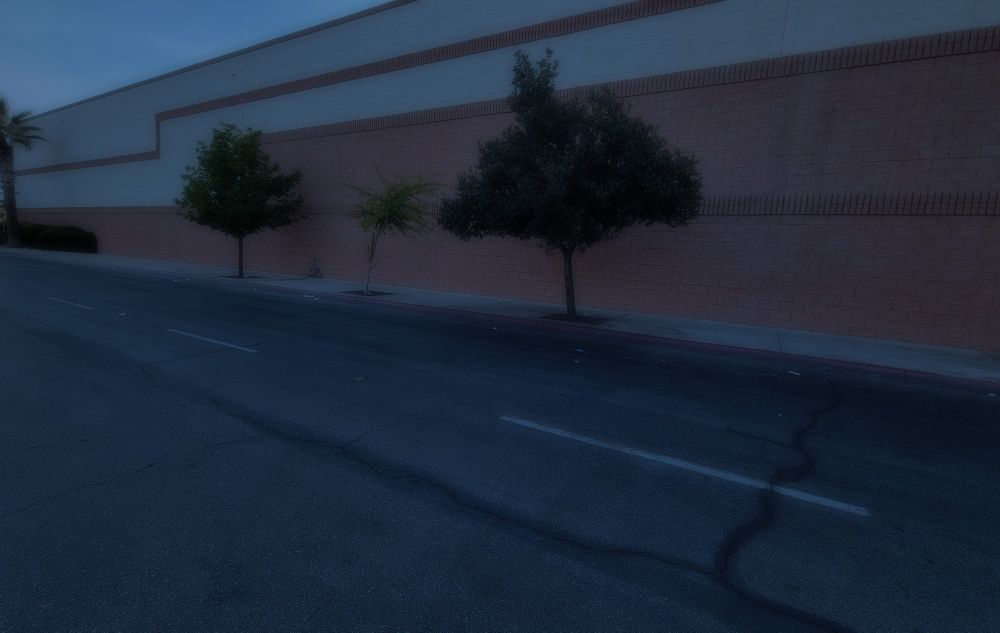 Outside of a mall on a dimly lit evening.