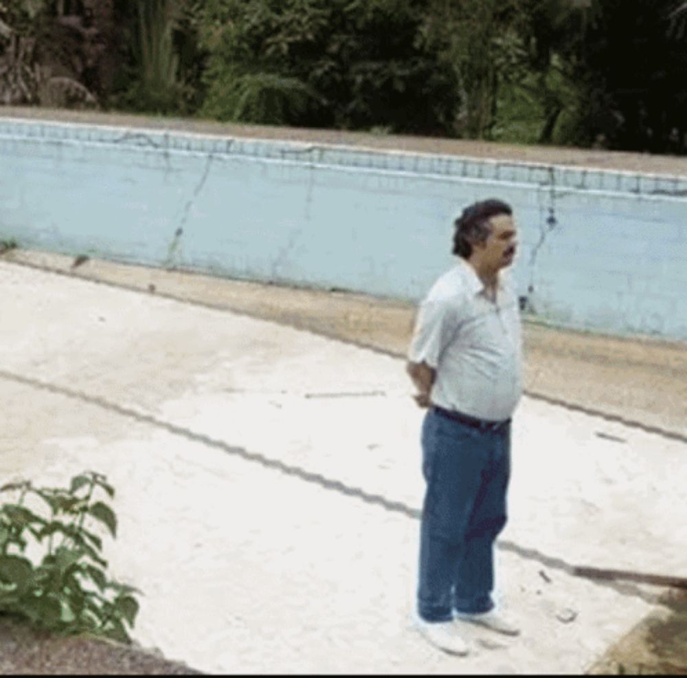 a man standing in front of a swimming pool