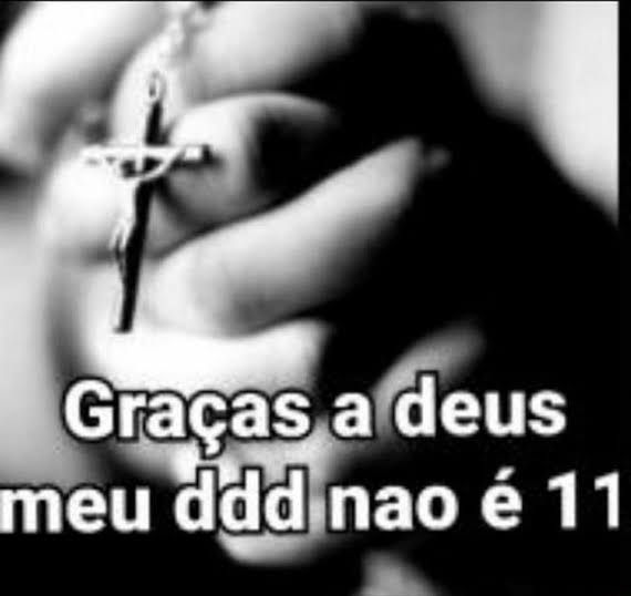 Imagem em preto e branco de mãos segurando um terço em gesto de oração, com a frase "graças a Deus meu DDD não é 11"