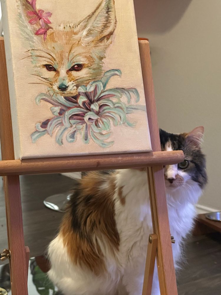 Painting of a fox with a croissant on an easel with a cat, looking at the viewer behind it 
