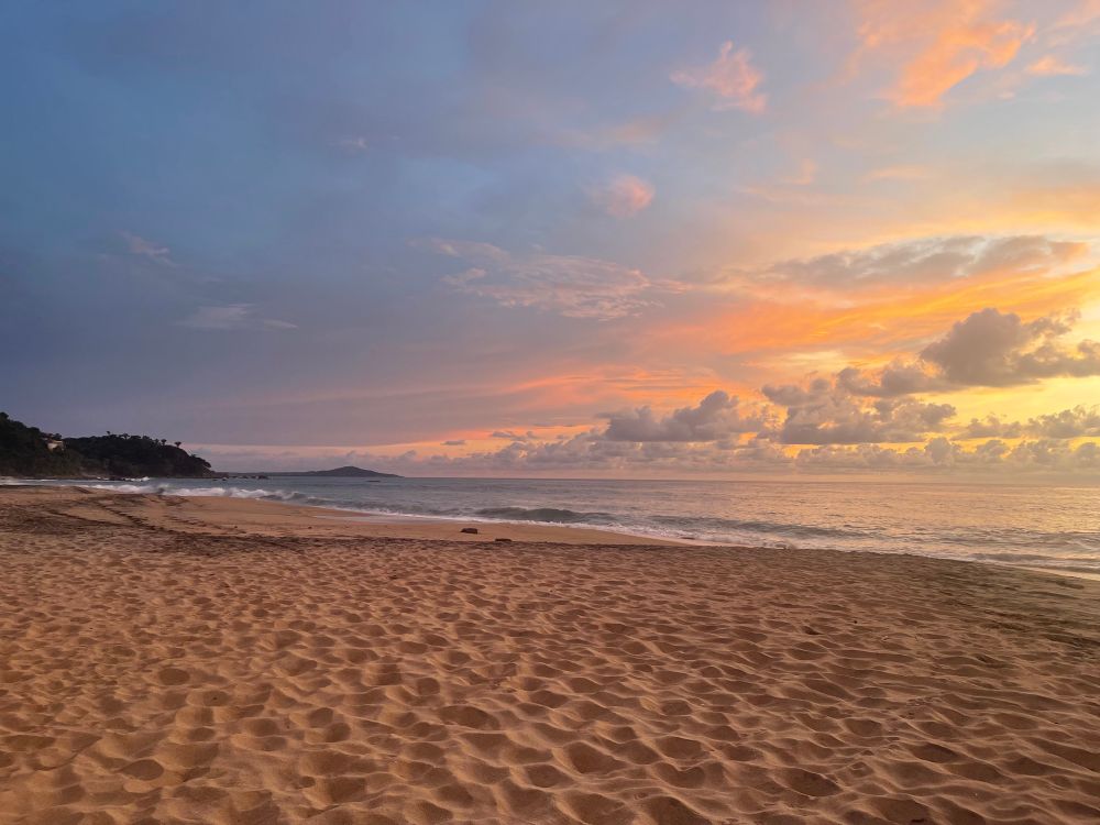 Beautiful shot of the beach at sunset with ridges in the sand and no people. 