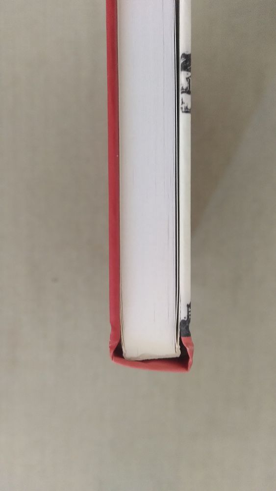 Hardback book viewed from above showing that the spine is skew whiff in relation to the pages and the boards
