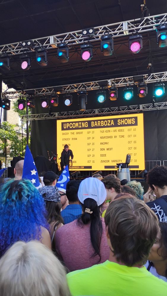 View of the stage about 10 people deep