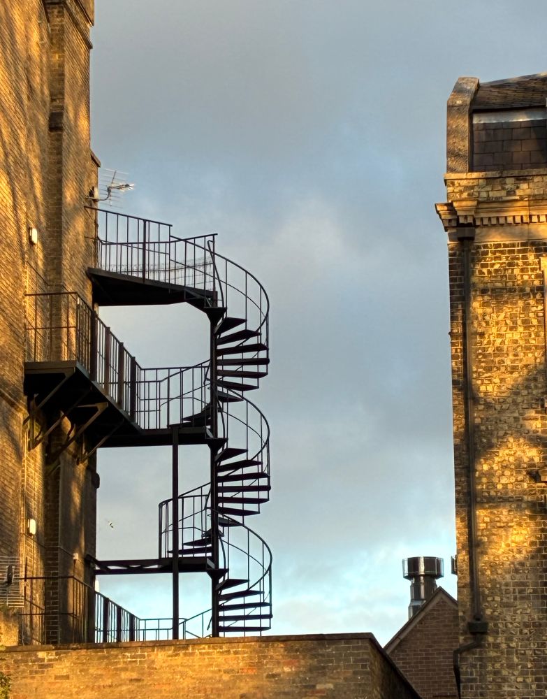 Fire escape on outside of sunlit building 