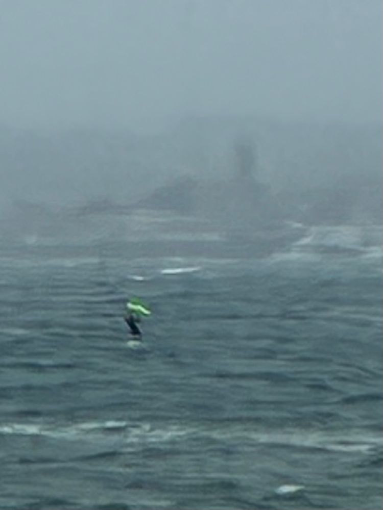 Foil surfer in rough sea off Cornish coast